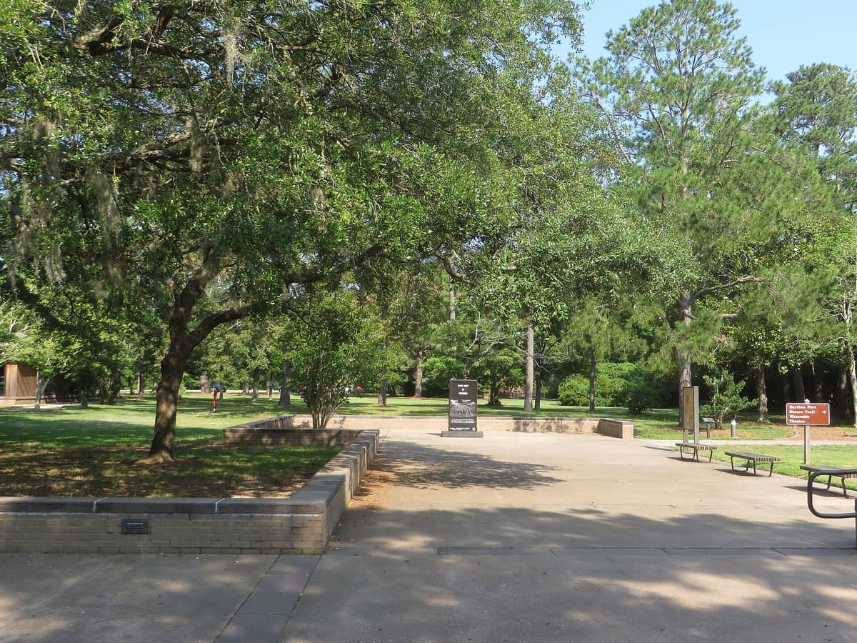 Live oaks shading the walkway and benches outside the Fort Raleigh visitor center