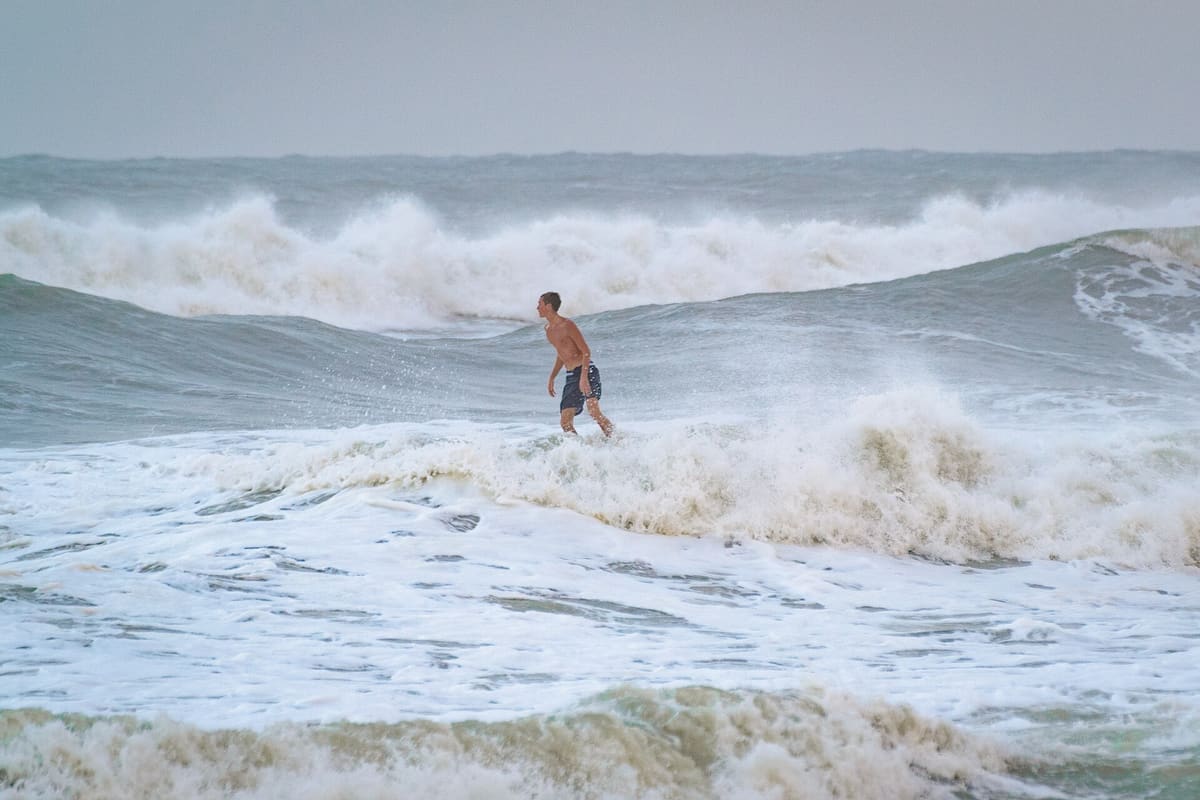 Choppy grey water and breaking surf off the end of the pier