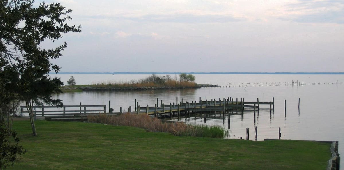 A dock and pilings on Currituck Sound seen from the Whalehead grounds